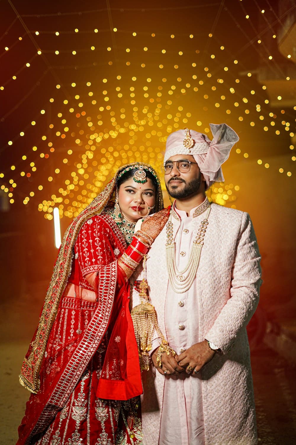 Bride and groom under wedding lights